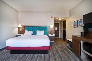 a hotel room with a bed and a flat screen tv at Hampton Inn & Suites Salinas in Salinas +29 photos