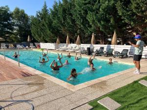 a group of people swimming in a swimming pool at Camping Mas Sud Ardèche in Saint-Just