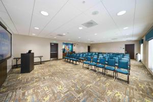 a conference room with blue chairs and a podium at Hampton Inn & Suites Salinas in Salinas