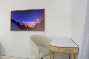 a room with a chair and a table and a picture at Elegant & Cozy Private Studio in Wellington Point
