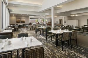 a dining room with tables and chairs in a restaurant at Doubletree by Hilton, Leominster in Leominster