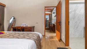a bedroom with a bed and a hallway with a table at Private Villa close to Ubud in Darmasaba +36 photos