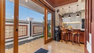 a kitchen and living room with a bar and a balcony at Private Villa close to Ubud in Darmasaba