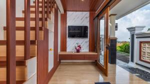 a staircase in a house with a window at Private Villa close to Ubud in Darmasaba