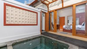 an indoor pool in a house with a bedroom at Private Villa close to Ubud in Darmasaba