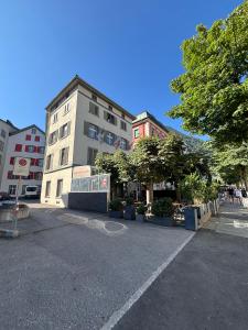 a parking lot in a city with buildings and trees at Haus zur Eiche Private 1 Zimmerstudios in Chur