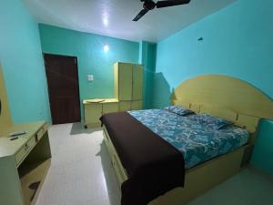 a bedroom with a bed and a ceiling fan at Dmello guesthouse in Palolem +19 photos