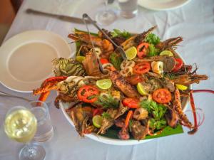 a plate of food with seafood and vegetables on a table at Zoi Retreat Hotel Zanzibar in Matemwe