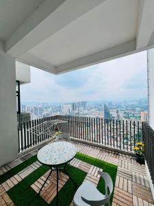a balcony with a table and chairs and a view at The Luxe Service Suites in Kuala Lumpur