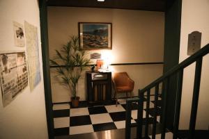a stairway with a chair and a table and a plant at Yangyang Bookers Beach Motel in Yangyang