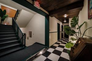 a room with a staircase and a checkered floor at Yangyang Bookers Beach Motel in Yangyang +16 photos