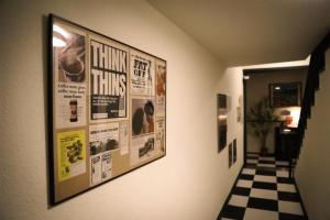 a hallway with posters on the wall and a checkered floor at Yangyang Bookers Beach Motel in Yangyang