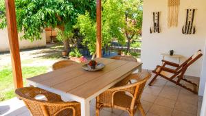 a wooden table and chairs on a patio at Isidoros House in Keramoti