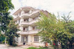 a large white building with trees in front of it at Suva Garden Hotel in Kathmandu