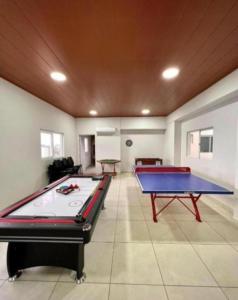 a large room with two ping pong tables in it at JG Hotel in Santa Cruz de la Sierra