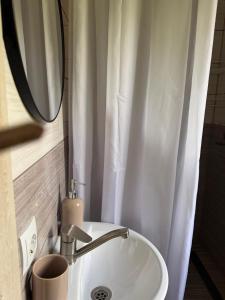a white sink in a bathroom with a mirror at Anamyra in Mizhhirya