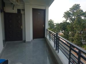 a balcony of a house with a door at Hotel rose palace in Dehradun