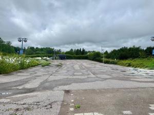 an empty parking lot with a cloudy at Fox Center Matkaparkki Järvenpää Only Parking Slot in Järvenpää