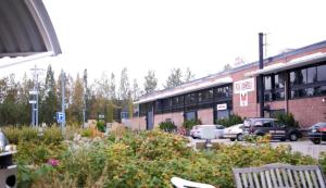 a parking lot with cars parked in front of a building at Fox Center Matkaparkki Järvenpää Only Parking Slot in Järvenpää