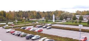 a parking lot with a bunch of cars parked in it at Fox Center Matkaparkki Järvenpää Only Parking Slot in Järvenpää