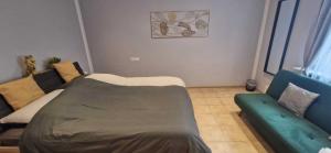 a living room with a bed and a couch at Ela´s Alstadtliebe in Wertheim