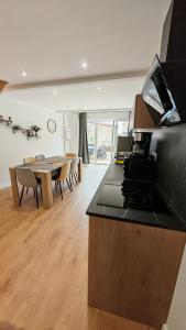 a kitchen and living room with a table and a counter at Clos de la Vigne Saint Roch in Crêches-sur-Saône