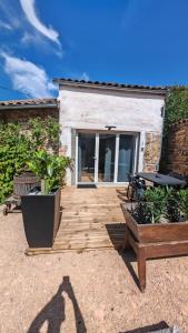 a wooden deck in front of a house at Clos de la Vigne Saint Roch in Crêches-sur-Saône