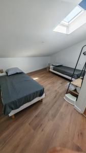 an attic bedroom with a bed and a skylight at Clos de la Vigne Saint Roch in Crêches-sur-Saône