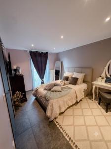 a bedroom with a large bed and a desk at O’Berges D’Astacus in Beloeil +56 photos