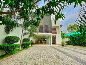 a house with a driveway in front of it at Kiula Resort in Hambantota