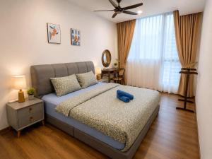 a bedroom with a bed with a blue teddy bear on it at Jazz Suite Vivacity Kuching in Kuching