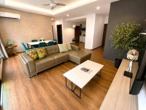 a living room with a couch and a table at Jazz Suite Vivacity Kuching in Kuching