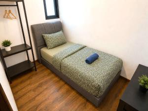 a couch sitting in a living room with a blue at Jazz Suite Vivacity Kuching in Kuching +103 photos