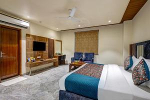 a hotel room with a bed and a desk at Lavanya Hotel- Near Alipur, Delhi in New Delhi