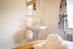 a bathroom with a sink and a mirror and towels at Chasa Macun in Schleins +98 photos