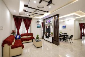 a living room with a couch and a dining room at Heaven Stay in Varkala