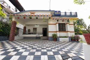 a house with a checkered floor in front of it at Heaven Stay in Varkala