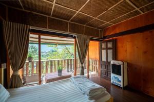 a bedroom with a bed and a large window at Vanhaus in Sapa