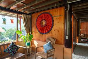 a room with two chairs and a wreath on a wall at Vanhaus in Sapa