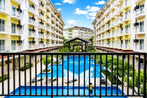 a view from the balcony of a apartment building with a swimming pool at Cebu Airport Layover Stay in Pusok