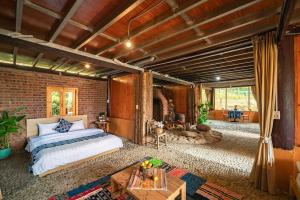 a bedroom with a bed and a brick wall at Vanhaus in Sapa