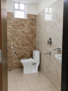 a bathroom with a toilet and a sink at Hotel GVR Prime in Guntūr +11 photos