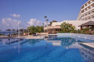a large swimming pool in front of a hotel at Atlantica Miramare Beach in Limassol