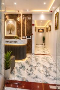 a lobby of a hotel with a reception counter at Hotel Prime Gold in Ahmedabad +18 photos