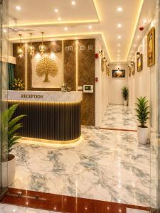 a lobby of a hotel with a reception desk at Hotel Prime Gold in Ahmedabad