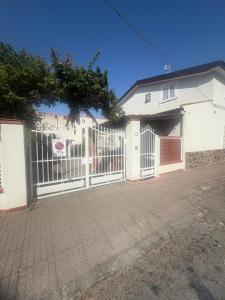 a white fence in front of a house at Lulù Marin Rooms in Scalea +27 photos