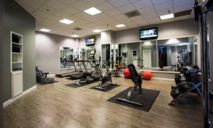 a gym with several treadmills and cardio machines at Hotel Deco in Omaha