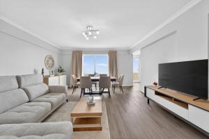a living room with a couch and a dining room at Calheta Atlantic Pearl in Calheta