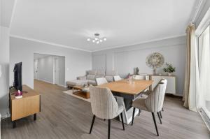 a dining room and living room with a table and chairs at Calheta Atlantic Pearl in Calheta