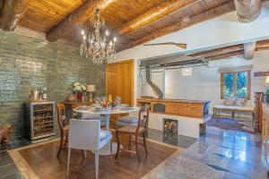 a dining room with a table and chairs and a fireplace at Villa São Jorge in São Jorge +22 photos
